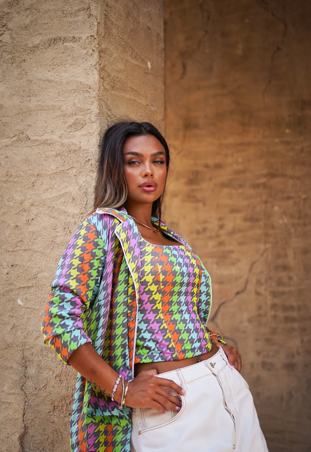 The GEM campaign — multicoloured houndstooth corset and jacket with white jeans